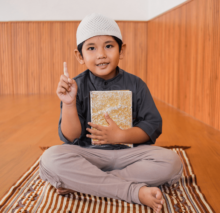 Niño musulmán levantando el dedo índice representando la Shahada, declaración de fe en el Islam